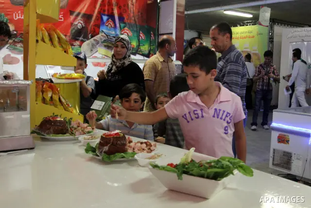 Palestinians participate in the opening of festival national products in the West Bank city of Nablus, on July, 14, 2012. Photo by Nedal Eshtayah