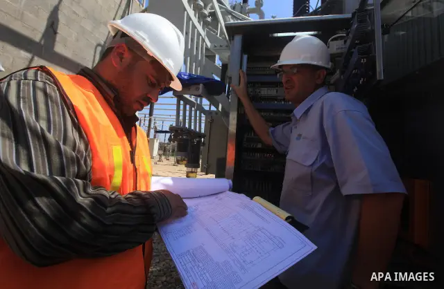 Palestinians workers work in energy company during maintenance work in Gaza city, on July 14, 2012. Photo by Majdi Fathi