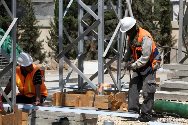 Palestinians workers work in energy company during maintenance work in Gaza city, on July 14, 2012. Photo by Majdi Fathi