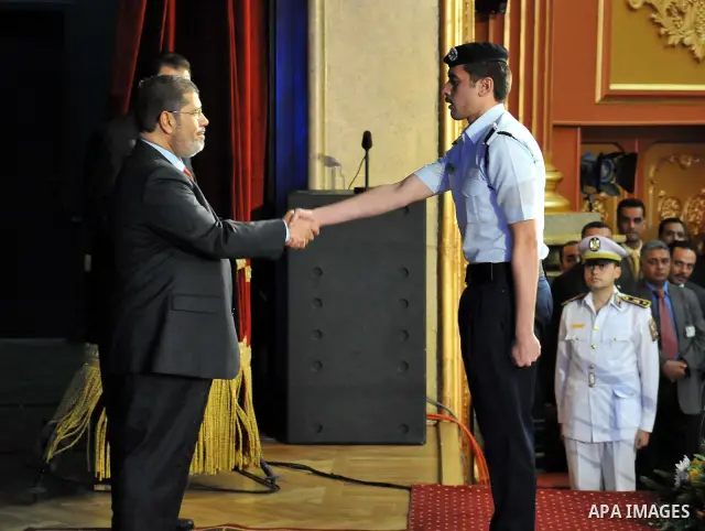 In this image released by the Egyptian Presidency, Egyptian President, Mohammed Morsi at a graduation ceremony at the Police Academy headquarters in Cairo, Egypt, July 14, 2012. The Police Academy was also the venue for...