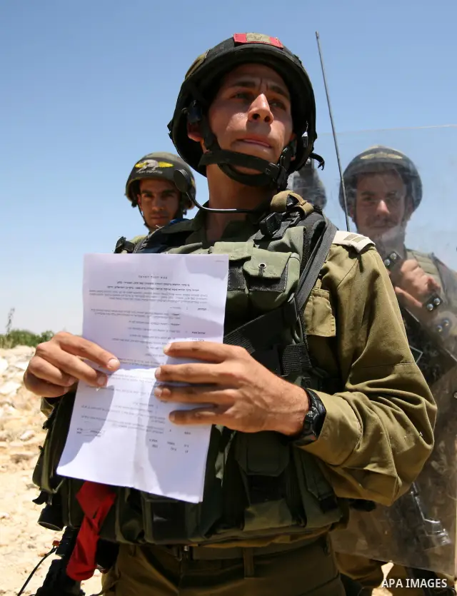 Palestinian and international demonstrators protest in the West Bank village of Susya, south Hebron, against pending demolition orders given by the Israeli Army, to demolish the village entrance, 14 July 2012. Photo by M...