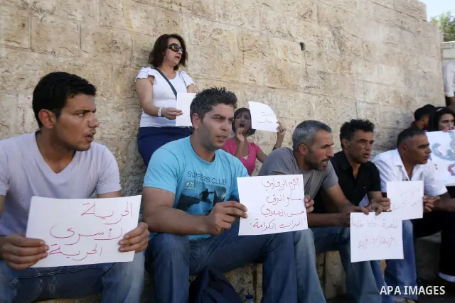 Palestinians take part a protest to calling of release of palestinian prisoners in Israeli jails whose are still refusing food for after a deal was made to end a mass prisoner hunger strike, during a demonstration in the...