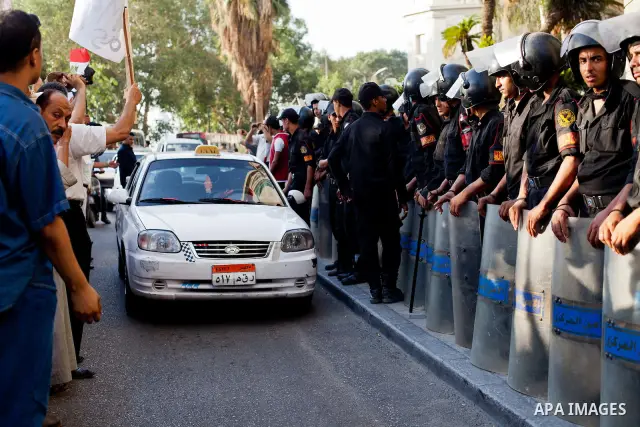 July 14, 2012 - Cairo, Egypt - Police officers guard the entrance of the Four Seasons Hotel, where US Secretary of State Hillary Clinton resides for her visit to Egypt. Egyptians surrounded the hotel entrance, protesting...