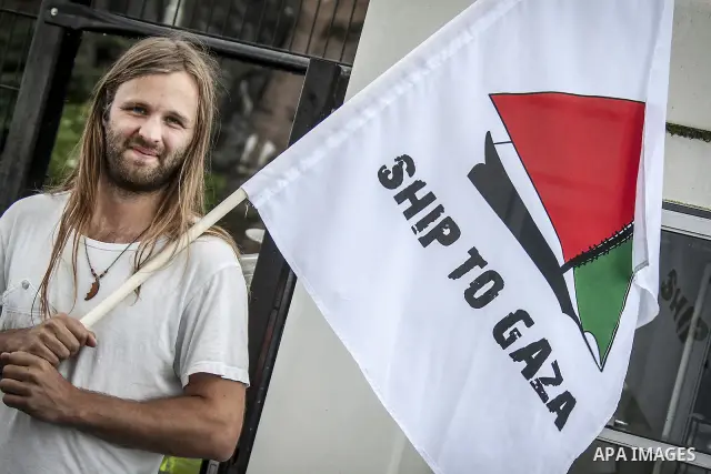 July 13, 2012 - Stockholm, Stockholms, Sweden - A member crew of the ''Ship to Gaza'' project waves a flag at the Skeppsbron port in Stockholm, where the humanitarian aid ship ''Estelle'' is ready to sets sail. The ship...
