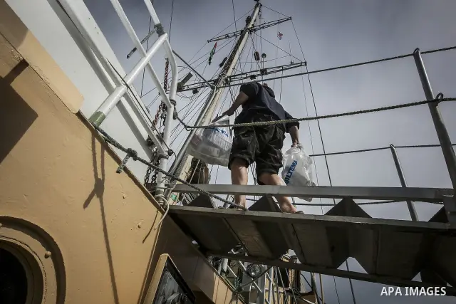 July 13, 2012 - Stockholm, Stockholm, Sweden - Member crew of the humanitarian aid ship ''Estelle'' gets ready to set sail at the Skeppsbron port in Stockholm. The ship is part of a pro-palestinian caravan which heads to...