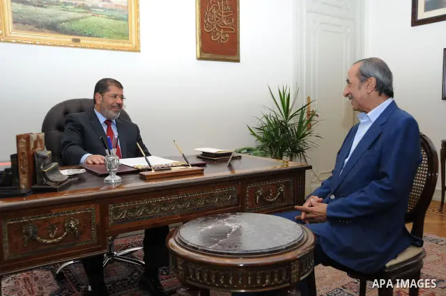 Egypt's president Mohamed Morsi, meets with journalist and Egyptian T.V presenter Hamdi Qandeel at the presidential palace in Cairo, July 14, 2012. Photo by apaimages/Egyptian Presidency/Mohamed Abd el Moaty