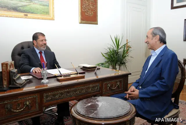Egypt's president Mohamed Morsi, meets with journalist and Egyptian T.V presenter Hamdi Qandeel at the presidential palace in Cairo, July 14, 2012. Photo by apaimages/Egyptian Presidency/Mohamed Abd el Moaty