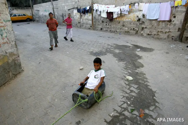 Palestinian children play outside their home in the Rafah refugee camp in the southern Gaza Strip on July 14, 2012. Photo by Eyad Al Baba