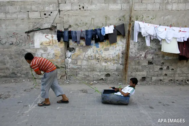 Palestinian children play outside their home in the Rafah refugee camp in the southern Gaza Strip on July 14, 2012. Photo by Eyad Al Baba