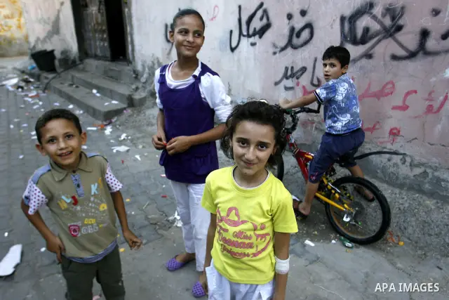 Palestinian children play outside their home in the Rafah refugee camp in the southern Gaza Strip on July 14, 2012. Photo by Eyad Al Baba