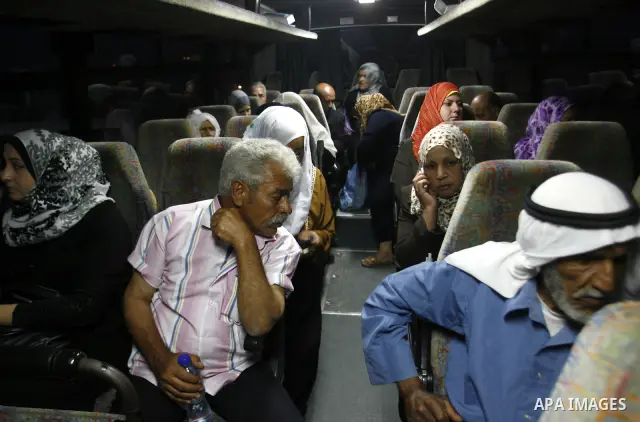 Family members of Palestinian prisoners on their way to visit their relatives jailed in Israel sit in a bus before it leaves Gaza City July 16, 2012. Israel on Monday allowed Palestinian families from the Gaza Strip to v...