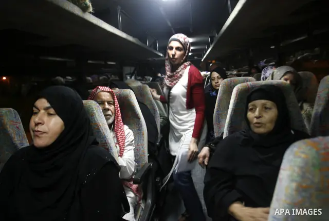 Family members of Palestinian prisoners on their way to visit their relatives jailed in Israel sit in a bus before it leaves Gaza City July 16, 2012. Israel on Monday allowed Palestinian families from the Gaza Strip to v...
