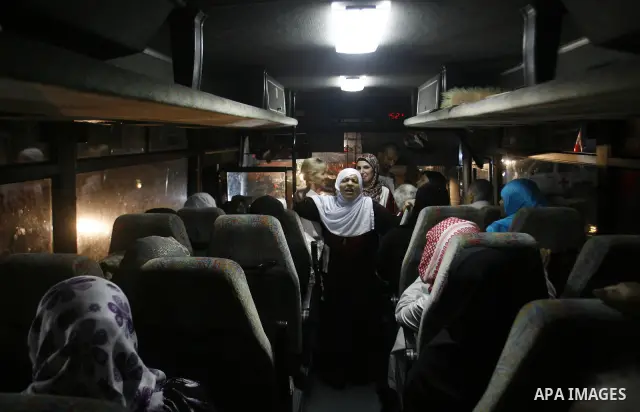 Family members of Palestinian prisoners on their way to visit their relatives jailed in Israel sit in a bus before it leaves Gaza City July 16, 2012. Israel on Monday allowed Palestinian families from the Gaza Strip to v...