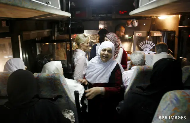 Family members of Palestinian prisoners on their way to visit their relatives jailed in Israel sit in a bus before it leaves Gaza City July 16, 2012. Israel on Monday allowed Palestinian families from the Gaza Strip to v...