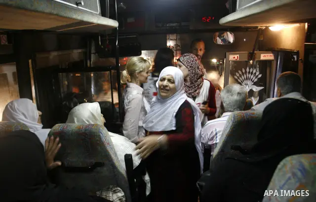 Family members of Palestinian prisoners on their way to visit their relatives jailed in Israel sit in a bus before it leaves Gaza City July 16, 2012. Israel on Monday allowed Palestinian families from the Gaza Strip to v...