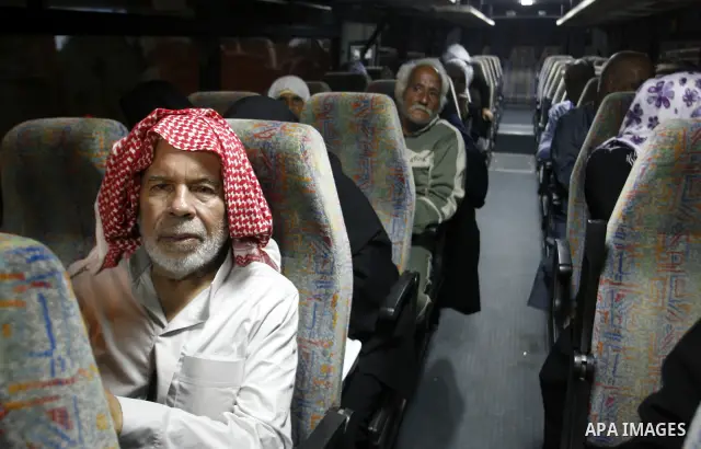 Family members of Palestinian prisoners on their way to visit their relatives jailed in Israel sit in a bus before it leaves Gaza City July 16, 2012. Israel on Monday allowed Palestinian families from the Gaza Strip to v...