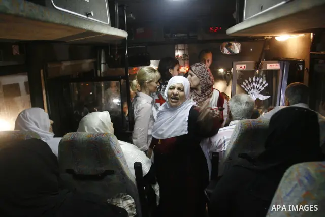 Family members of Palestinian prisoners on their way to visit their relatives jailed in Israel sit in a bus before it leaves Gaza City July 16, 2012. Israel on Monday allowed Palestinian families from the Gaza Strip to v...