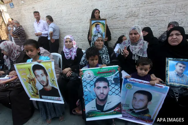 Palestinian relatives prisoners attend a protest calling for the release of their sons held in Israeli jails in front of the headquarters Red Cross in Gaza City, Gaza Strip, on July.16, 2012. Photo by Ashraf Amra