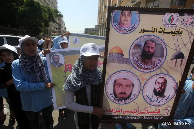 Palestinian relatives prisoners attend a protest calling for the release of their sons held in Israeli jails in front of the headquarters Red Cross in Gaza City, Gaza Strip, on July.16, 2012. Photo by Ashraf Amra