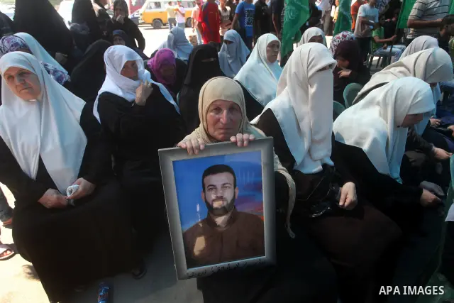 Palestinian relatives prisoners attend a protest calling for the release of their sons held in Israeli jails in front of the headquarters Red Cross in Gaza City, Gaza Strip, on July.16, 2012. Photo by Ashraf Amra