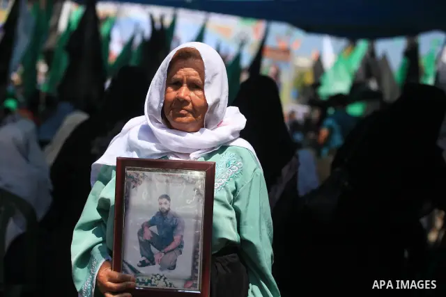 A Palestinian woman holds picture of her son during a protest calling for the release of prisoners held in Israeli jails in front of the headquarters Red Cross in Gaza City, on July.16, 2012. Photo by Majdi Fathi