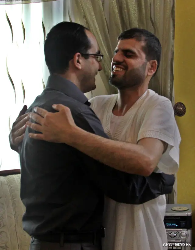 Palestinian former prisoner Adnan Asfour belonging to Hamas movement, greets his family at their home in the West Bank city of Nablus, after being release of prisoners held in Israeli jails, on July 16, 2012. Photo by Ne...