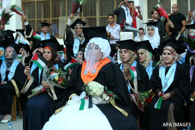 Palestinian bride celebrates her marriage during graduation ceremony at Al-Quds Open University in the West Bank city of Nablus, on July 16, 2012. Photo by Nedal Eshtayah