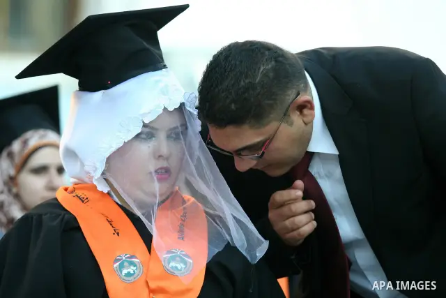 Palestinian bride celebrates her marriage during graduation ceremony at Al-Quds Open University in the West Bank city of Nablus, on July 16, 2012. Photo by Nedal Eshtayah