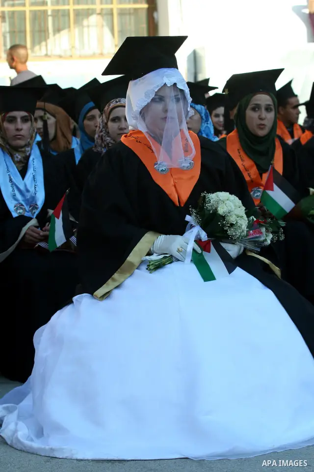 Palestinian bride celebrates her marriage during graduation ceremony at Al-Quds Open University in the West Bank city of Nablus, on July 16, 2012. Photo by Nedal Eshtayah