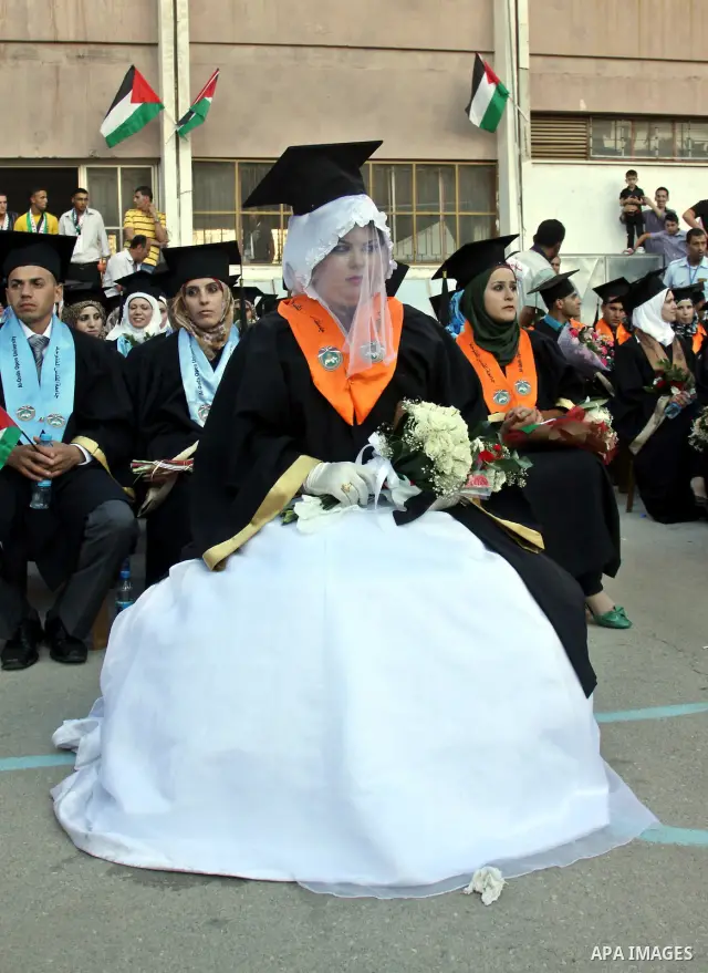Palestinian bride celebrates her marriage during graduation ceremony at Al-Quds Open University in the West Bank city of Nablus, on July 16, 2012. Photo by Nedal Eshtayah