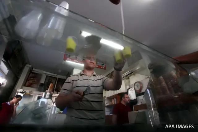 A Palestinian vendor sells ice-cream during hot weather in Gaza city, July 16, 2012. The temperature of the Gaza strip reaches more than 33 degrees Celsius and 61% humidity, Gazans escape to the beach and out from their...