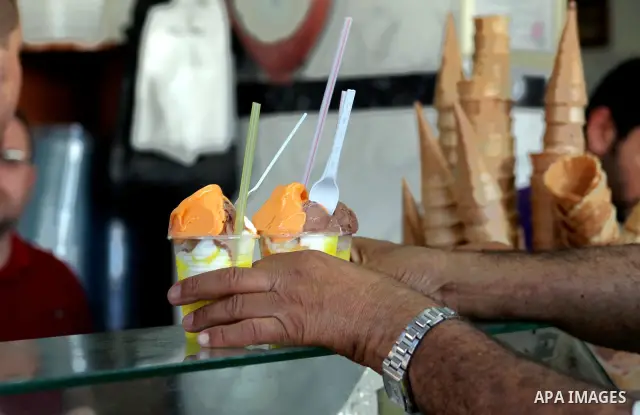 Palestinians buy ice-cream during hot weather in Gaza city, July 16, 2012. The temperature of the Gaza strip reaches more than 33 degrees Celsius and 61% humidity, Gazans escape to the beach and out from their homes duri...