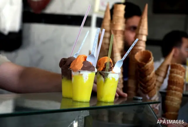 Palestinians buy ice-cream during hot weather in Gaza city, July 16, 2012. The temperature of the Gaza strip reaches more than 33 degrees Celsius and 61% humidity, Gazans escape to the beach and out from their homes duri...
