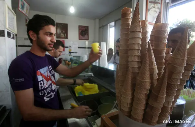 A Palestinian vendor sells ice-cream during hot weather in Gaza city, July 16, 2012. The temperature of the Gaza strip reaches more than 33 degrees Celsius and 61% humidity, Gazans escape to the beach and out from their...