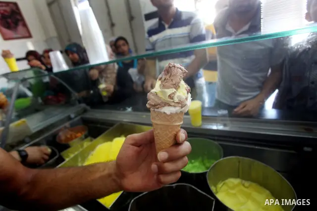 A Palestinian vendor sells ice-cream during hot weather in Gaza city, July 16, 2012. The temperature of the Gaza strip reaches more than 33 degrees Celsius and 61% humidity, Gazans escape to the beach and out from their...
