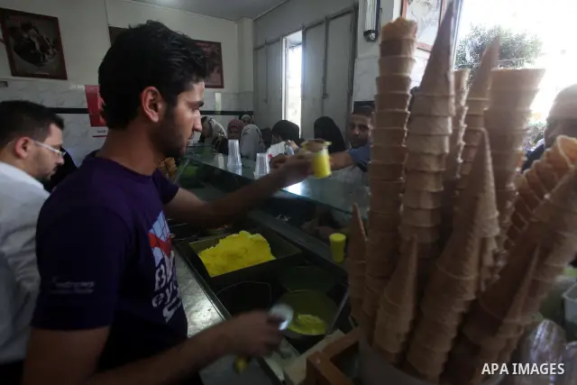 A Palestinian vendor sells ice-cream during hot weather in Gaza city, July 16, 2012. The temperature of the Gaza strip reaches more than 33 degrees Celsius and 61% humidity, Gazans escape to the beach and out from their...