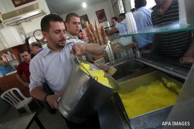 A Palestinian vendor sells ice-cream during hot weather in Gaza city, July 16, 2012. The temperature of the Gaza strip reaches more than 33 degrees Celsius and 61% humidity, Gazans escape to the beach and out from their...