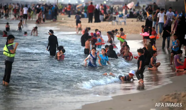Palestinians enjoy swimming in the sea at Gaza beach during hot weather in Gaza city, July 16, 2012. The temperature of the Gaza strip reaches more than 33 degrees Celsius and 61% humidity, Gazans escape to the beach and...