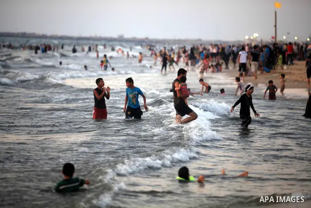 Palestinians enjoy swimming in the sea at Gaza beach during hot weather in Gaza city, July 16, 2012. The temperature of the Gaza strip reaches more than 33 degrees Celsius and 61% humidity, Gazans escape to the beach and...