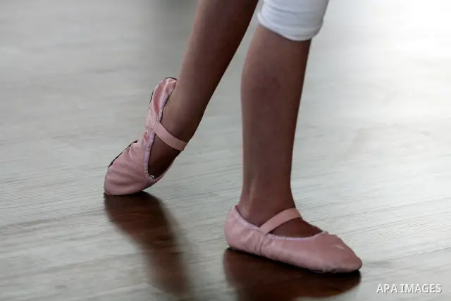 A Palestinian girl practises finger movements during a ballet class at the Ramallah Ballet Center dance school in the West Bank city of Ramallah July 17, 2012. The center is the first in the occupied West Bank. Picture t...
