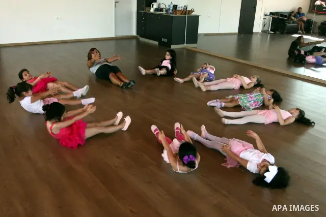 Palestinian ballet trainer, Shyrine Ziadeh , teaches young girls during summer classes at her Ramallah Ballet Center dance school, in the West bank town of Ramallah, 17 July 2012. The center teaches ballet techniques and...