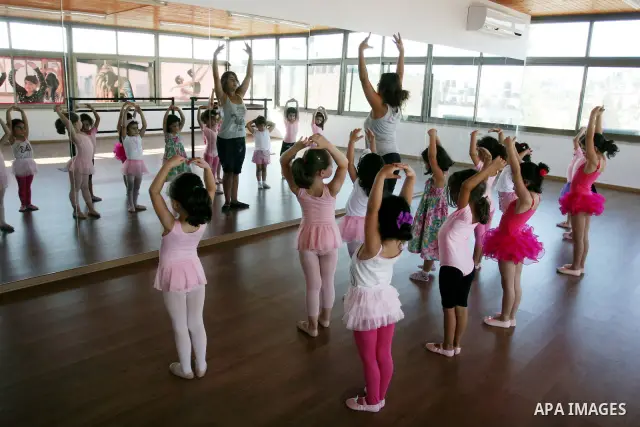 Palestinian ballet trainer, Shyrine Ziadeh , teaches young girls during summer classes at her Ramallah Ballet Center dance school, in the West bank town of Ramallah, 17 July 2012. The center teaches ballet techniques and...