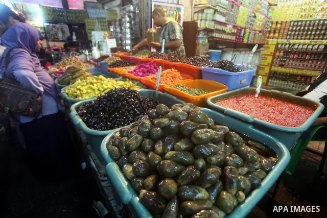 Palestinians Inspect goods as the vendor displays it in preparation for the holy month of Ramadan in the Gaza city on July 17, 2012 . Islam's holy month of Ramadan will begin in few days depending on the sighting of the...