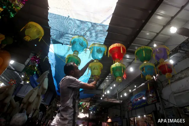 A Palestinian vendor decorates his shop in preparation for the holy month of Ramadan in the Gaza city on July 17, 2012 . Islam's holy month of Ramadan will begin in few days depending on the sighting of the crescent moon...