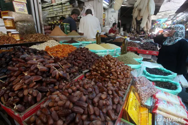 Palestinians Inspect goods as the vendor displays it in preparation for the holy month of Ramadan in the Gaza city on July 17, 2012 . Islam's holy month of Ramadan will begin in few days depending on the sighting of the...