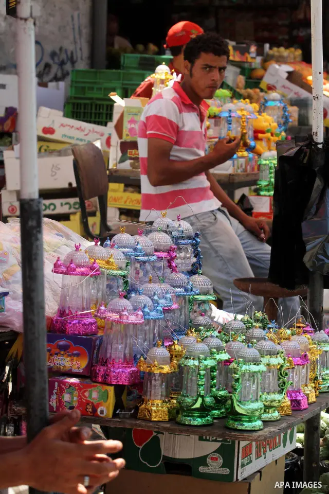 A Palestinian vendor displays goods in preparation for the holy month of Ramadan in the Gaza city on July 17, 2012 . Islam's holy month of Ramadan will begin in few days depending on the sighting of the crescent moon. Mu...
