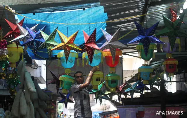 A Palestinian vendor decorates his shop in preparation for the holy month of Ramadan in the Gaza city on July 17, 2012 . Islam's holy month of Ramadan will begin in few days depending on the sighting of the crescent moon...