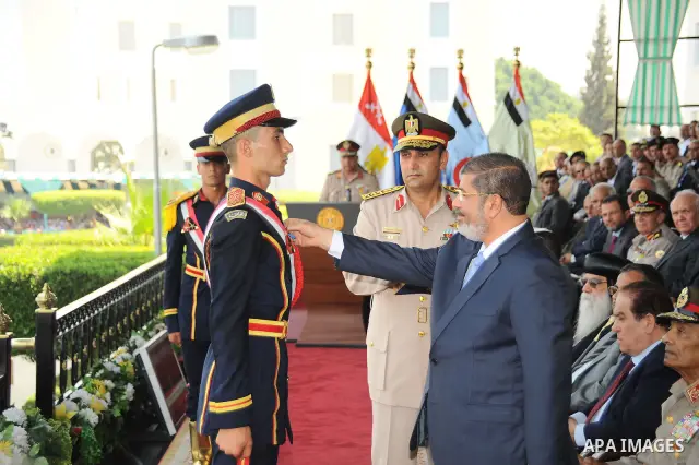 Egyptian President Mohamed Morsi honoring a military cadet during a medal ceremony for graduates at the Egyptian Military Academy in Cairo July 17, 2012. Fadi Fares / Egyptian Presidency