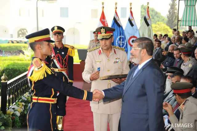 Egyptian President Mohamed Morsi honoring a military cadet during a medal ceremony for graduates at the Egyptian Military Academy in Cairo July 17, 2012. Fadi Fares / Egyptian Presidency