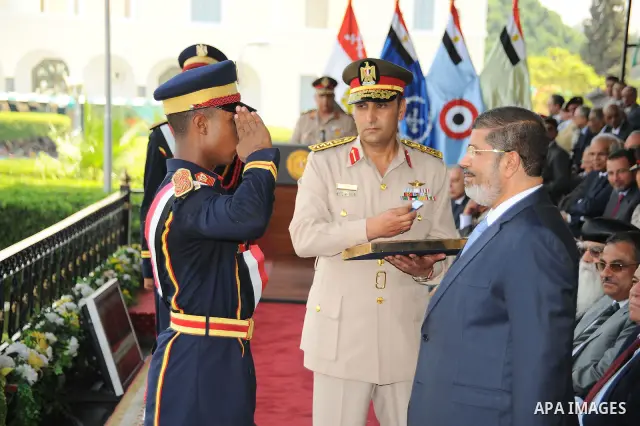 Egyptian President Mohamed Morsi honoring a military cadet during a medal ceremony for graduates at the Egyptian Military Academy in Cairo July 17, 2012. Fadi Fares / Egyptian Presidency